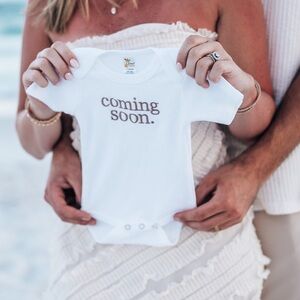 White Baby Onesie with 'Coming Soon' Print